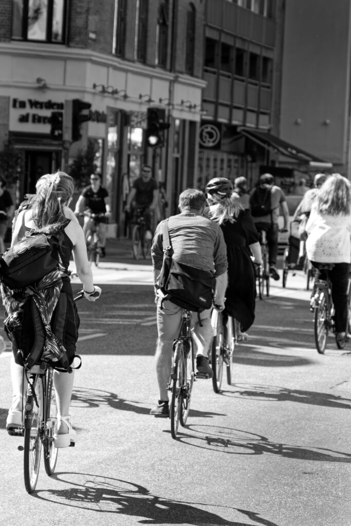 Black and white photo of cyclists commuting to work, promoting sustainable transportation and cycling community